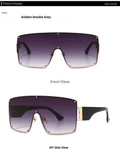 Detail of oversized shield sunglasses with golden metal hinges and purple gradient lenses