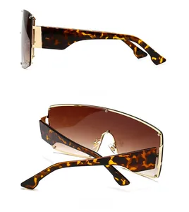 Side and back view of punk style oversized sunglasses with gold metal studs and tortoise legs