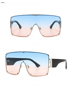 Detail of punk style oversized sunglasses with blue pink gradient lens and wide black arms