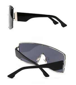 Detail showing side and back views of black oversized punk sunglasses with gold hinges