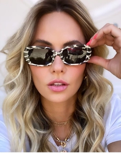 Close-up of narrow rectangular sunglasses with retro black and white zebra pattern