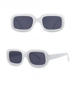 Detail view of retro rectangle sunglasses in white frames with dark grey lenses