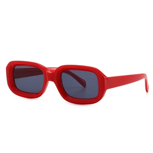 Modern rectangle sunglasses with thick red frames and dark grey lenses for street style