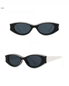 Detail view of retro cat-eye sunglasses with silver metal trim and dark grey lenses
