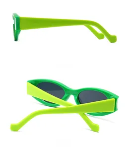 Detail view of bright green cat eye sunglasses featuring thick temples and dark lenses