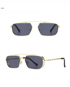 Dual-beam gold metal frame sunglasses with grey lenses and detailed openwork temples