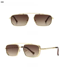 Detail view of golden metal sunglasses with gradient tan lenses and geometric hollow temples