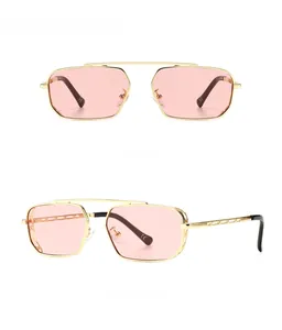Detail view of golden geometric frame sunglasses with golden pink lenses and CE marking