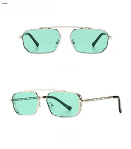 Detail view of retro square silver sunglasses with cyan lenses and hollow carved temples
