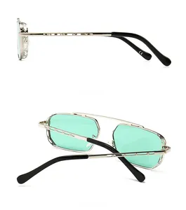 Detail view of silver metal hollow frame sunglasses with mint green lenses and CE mark