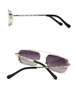 Detail of silver aviator sunglasses with purple gradient lenses and hollow temple design