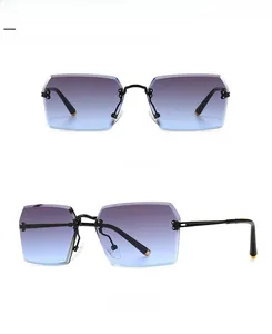 Detail view of square rimless sunglasses with black gray blue gradient lenses and metal temples