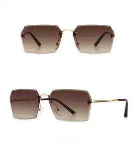 Modern rimless rectangular sunglasses with gold temples and golden tan gradient lenses