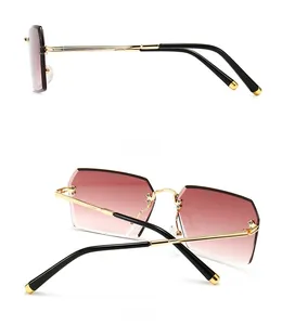 Side and back view of rimless rectangular sunglasses with pink gradient lenses and gold frame