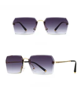 Detail of rimless square sunglasses with gold metal bridge and gradient lenses