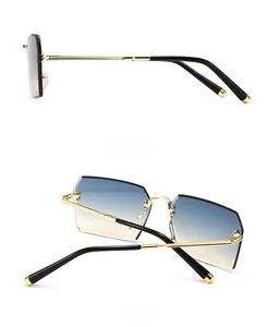 Detail view of modern rimless sunglasses with gradient lenses and gold metal temples