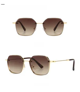 Detailed views of narrow golden metal sunglasses with tan gradient lenses in two angles
