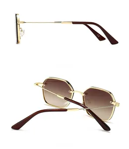 Detail view of gold metal polygon sunglasses with brown gradient lenses and CE mark