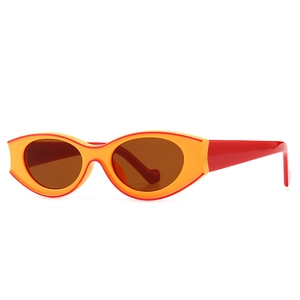 Vintage rock style oval sunglasses with bold orange frames and sleek red temples