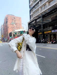 Street style view of modern retro small round sunglasses with trendy outfit combination