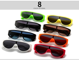 Flat lay of retro small round shield sunglasses in 8 vibrant colors with wide plastic frames