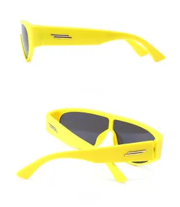 Detailed side view of yellow sunglasses with golden parallel bar metal accents
