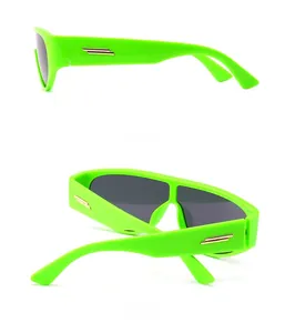 Detail of neon green sunglasses with gold metal hardware and black tinted lenses