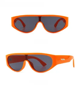 Front and side view of modern retro narrow round sunglasses with orange frames and dark lenses
