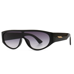 Modern oval sunglasses with black frames, grey gradient lenses and gold temple accents