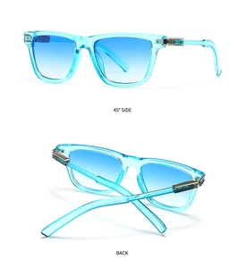 Detailed side view of butterfly sunglasses with blue gradient lenses and carved metal temples