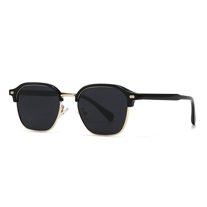 Classic semi-rimless sunglasses with black top frame and gold metal accents on white backdrop