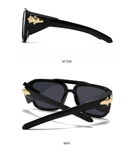 Macro view of wide black sunglasses frames showing gold metal hinge and 90 degree side details