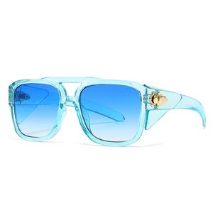 Modern oversized light blue translucent sunglasses with gold insect detail on the temple