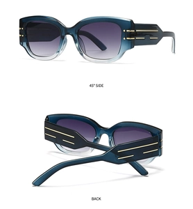 Detail view of cat eye sunglasses with blue gradient lenses and gold striped temple accents