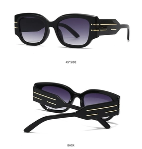 Detail view of cat eye sunglasses showing gold temple stripes and gradient purple lenses