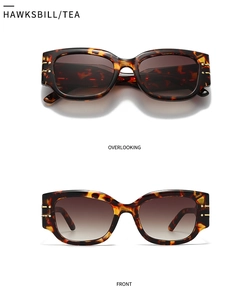 Close-up of hawksbill tea cat-eye sunglasses with gradient lenses and gold accents