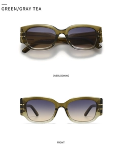 Detail of retro cat-eye sunglasses with green frames and purple gradient lenses