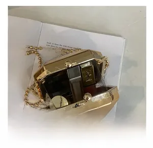 Detail showing the internal capacity of the golden octagonal metal clutch with chain