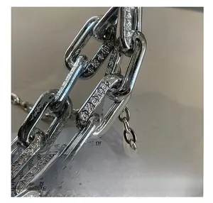 Macro shot of silver acrylic bag handle chain with gothic embossed patterns and details