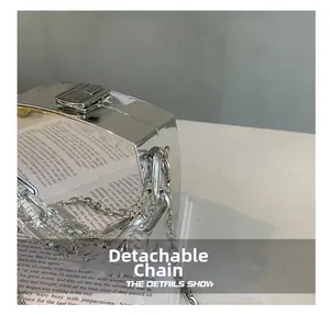 Detail view of silver mirror acrylic box bag with detachable metal chain and lock