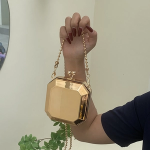 Octagonal gold geometric hard shell clutch bag with mirror finish and bead chain strap