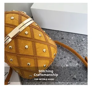 Macro shot of pineapple bag showing lychee leather stitching and golden rivets detail