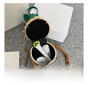 Detail showing the internal capacity of the pineapple chain bag with everyday essentials