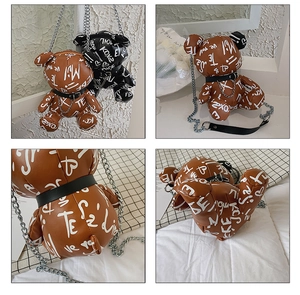 Close-up of bear-shaped bags with artistic graffiti print and metal chain straps