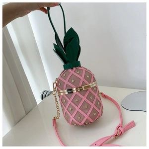 Macro detail of pineapple bag showing pink quilted texture and golden metal rivets