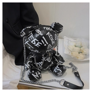 Detail of artistic graffiti bear-shaped chain crossbody bag made of shiny black PU leather