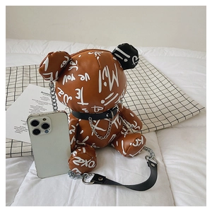 Detail of cartoon bear crossbody bag with graffiti print and silver chain strap