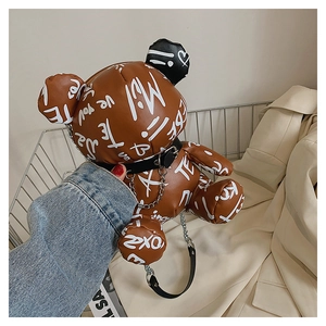 Detailed view of bear-shaped PU leather crossbody bag with artistic white graffiti pattern