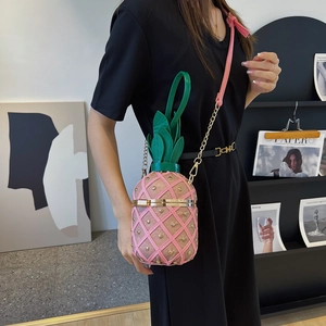 Creative pink pineapple cross-body bag with gold studs and green leaf top handle