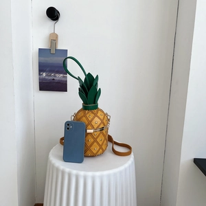 Quirky pineapple-shaped shoulder bag with rivet accents and metallic chain strap